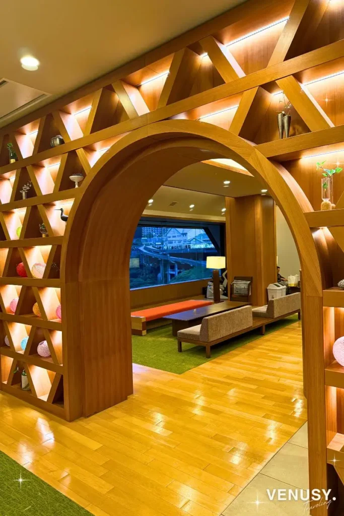 Warm wooden arches and Kurobe Gorge views in the Unazuki Yamanoha lobby at night