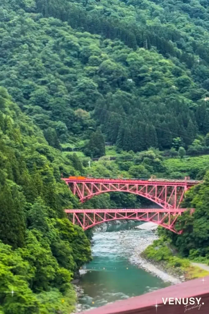 Kurobe Gorge Railway train crossing Shin-Yamabiko Bridge, seen from our Yamanoha guest room
